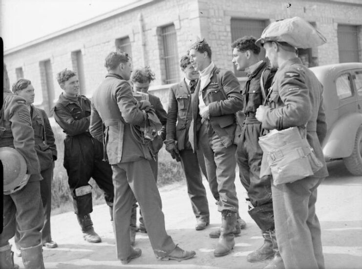Members of No. 73 Squadron RAF standing together outside of their Operations Building