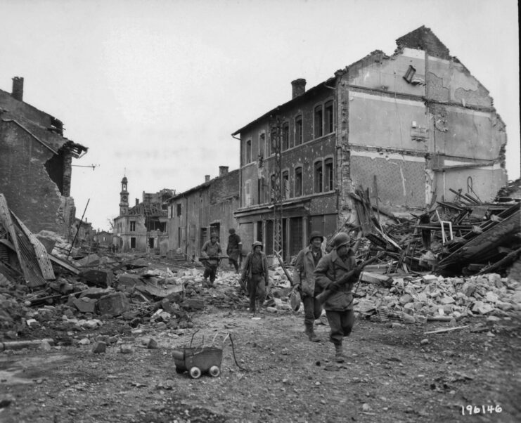 American infantrymen walking along a debris-filled street