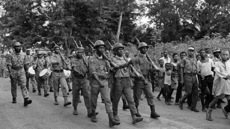 Nigerian soldiers marching along a street
