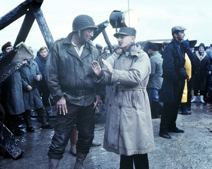 Robert Mitchum standing with Darryl Zanuck on the set of 'The Longest Day'