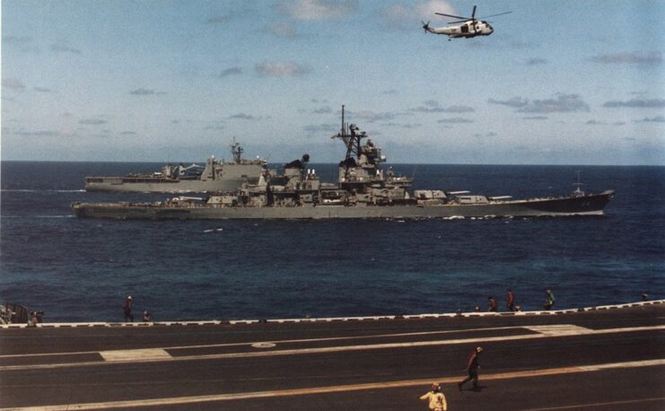 Sikorsky SH-3H Sea King flying over the USS Wisconsin (BB-64)