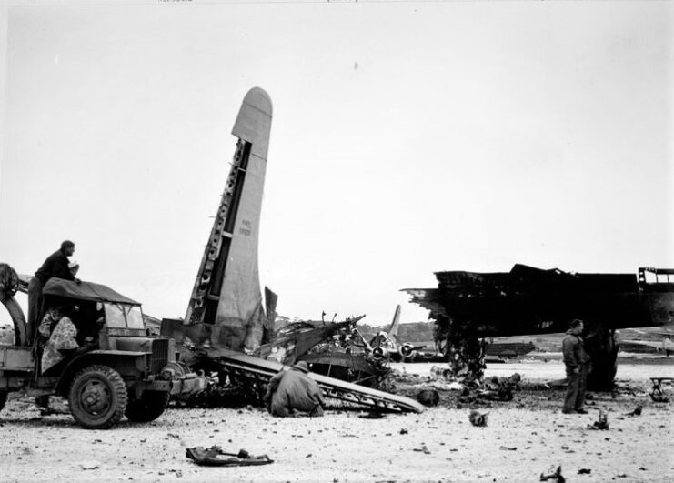 American serviceman looking at destroyed aircraft