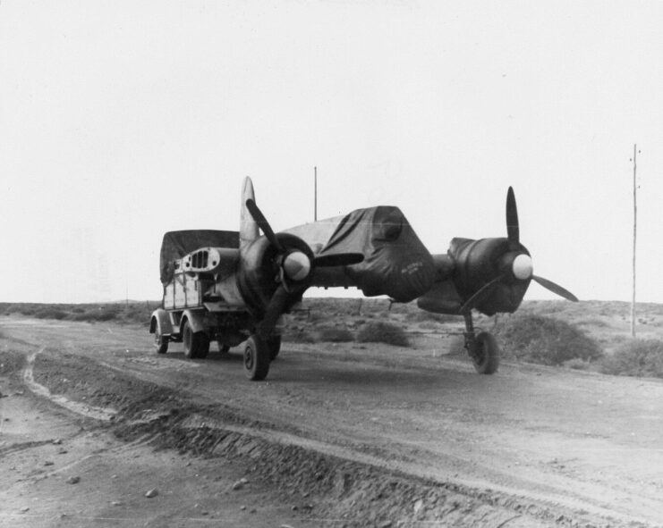 Wingless Henschel Hs 129 being towed down a dirt road by an Opel Blitz