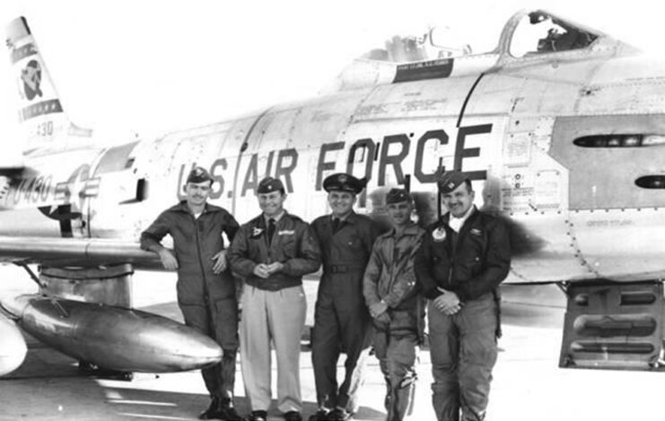 Coleman Baker, Chuck Yeager, Fred Ascani, James Gasser and Robert Pasqualicchio standing in front of an aircraft