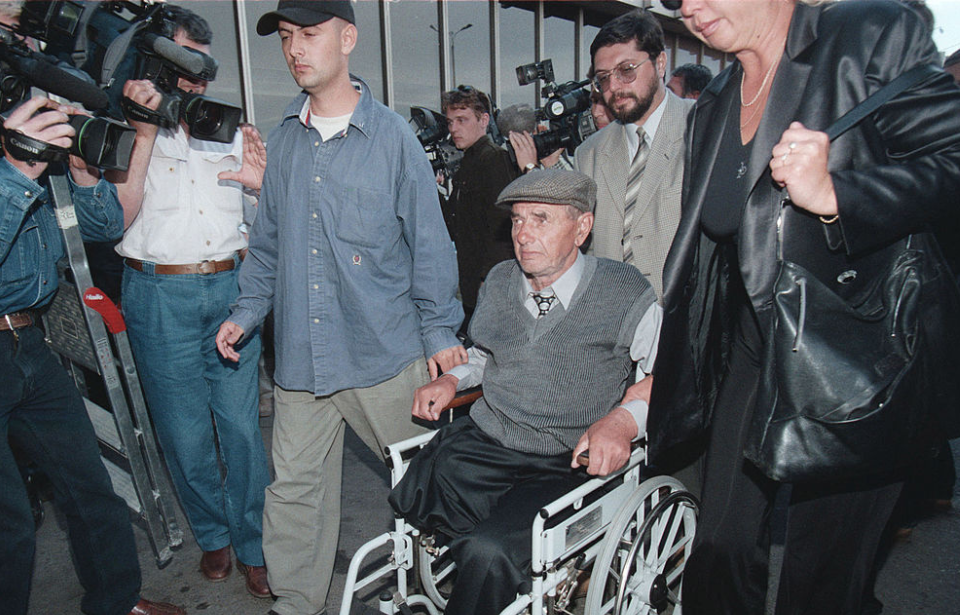 András Toma being pushed through a crowd while sat in a wheelchair