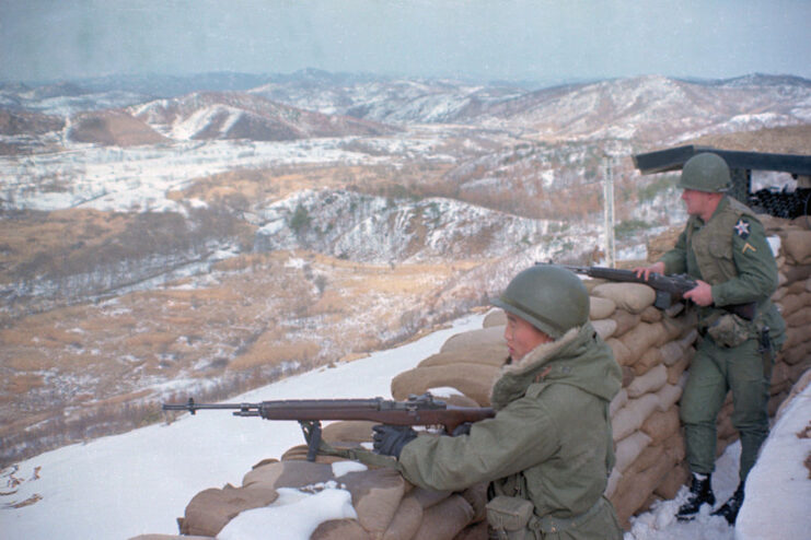 Two American troops manning rifles along the Korean Demilitarized Zone (DMZ)