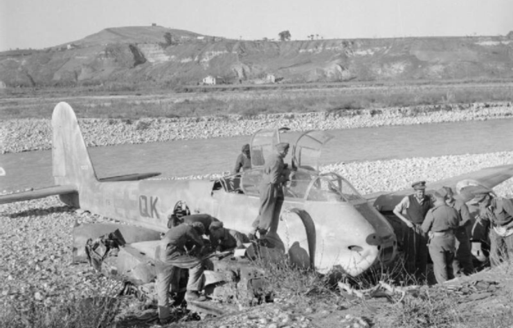 Royal Air Force (RAF) personnel standing around a downed Messerschmitt Me 410 Hornisse