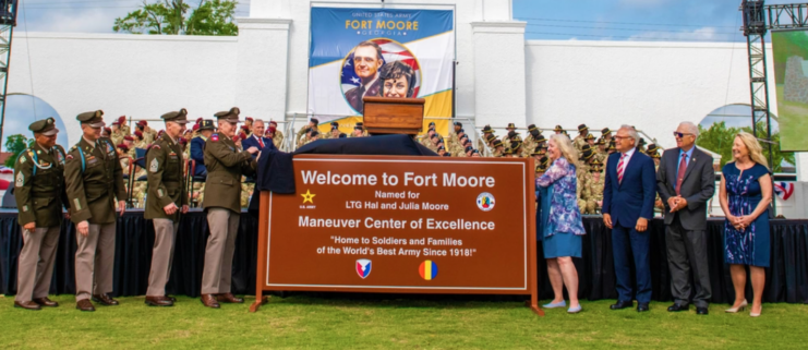 Military leaders and members of the Moore family unveiling the new sign at Fort Moore