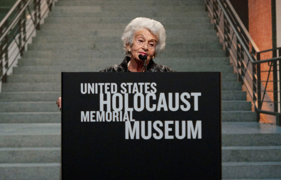 Gerda Weissmann Klein standing at a podium