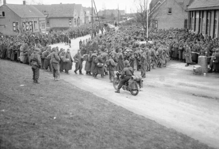German prisoners of war (POWs) gathered along a street
