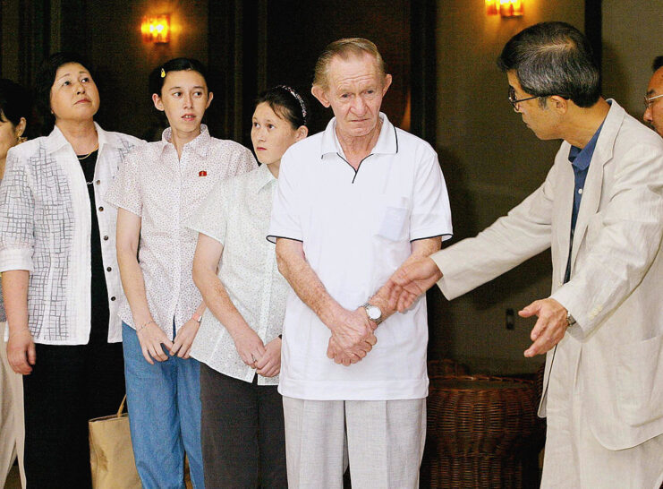 Charles Robert Jenkins, Hitomi Soga and their two daughters, Brinda and Mika, standing with Yutaka Iimura