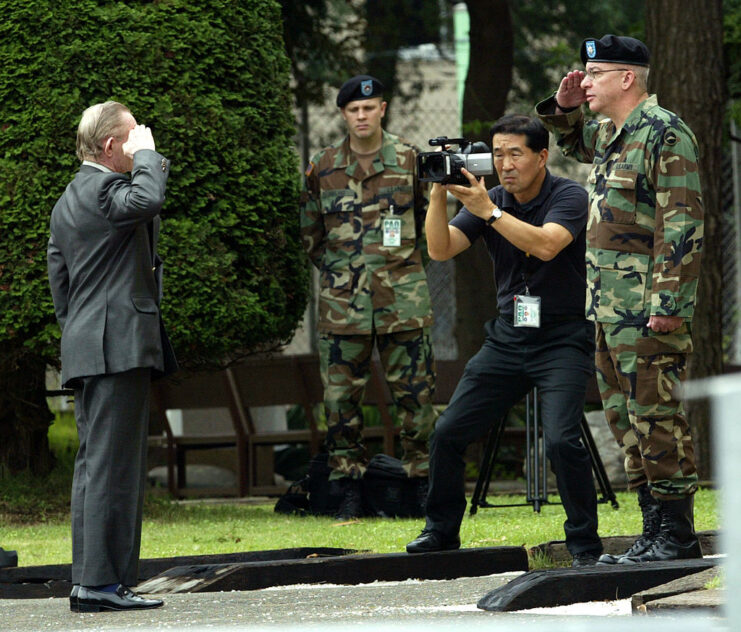 Cameraman filming as Charles Robert Jenkins salutes Paul Nigara