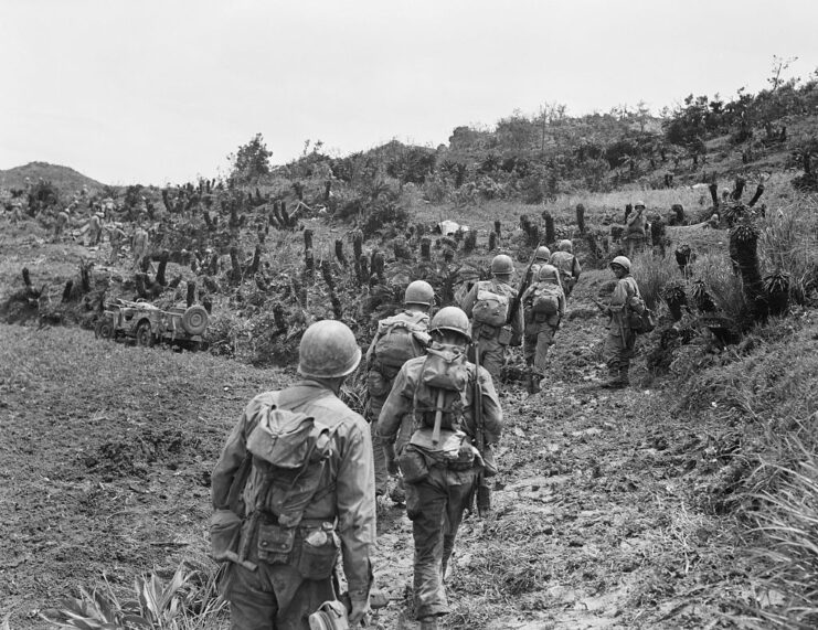 US Marines walking up a steep hill on Okinawa