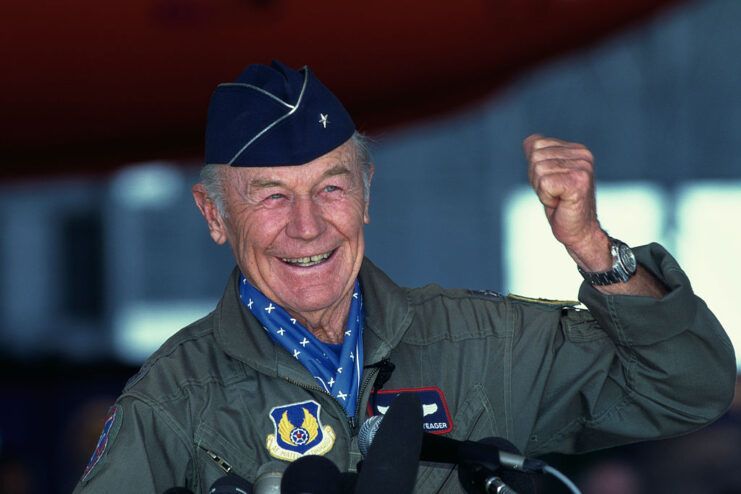 Chuck Yeager speaking in front of microphones