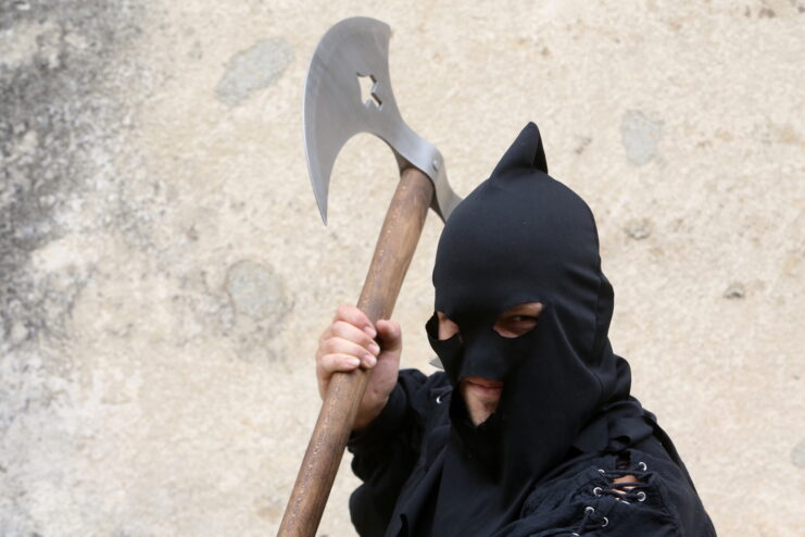 Man dressed as a medieval executioner, holding a large axe