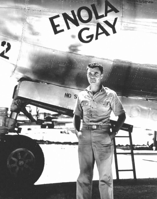 Paul Tibbets standing beside the Boeing B-29 Superfortress 'Enola Gay'