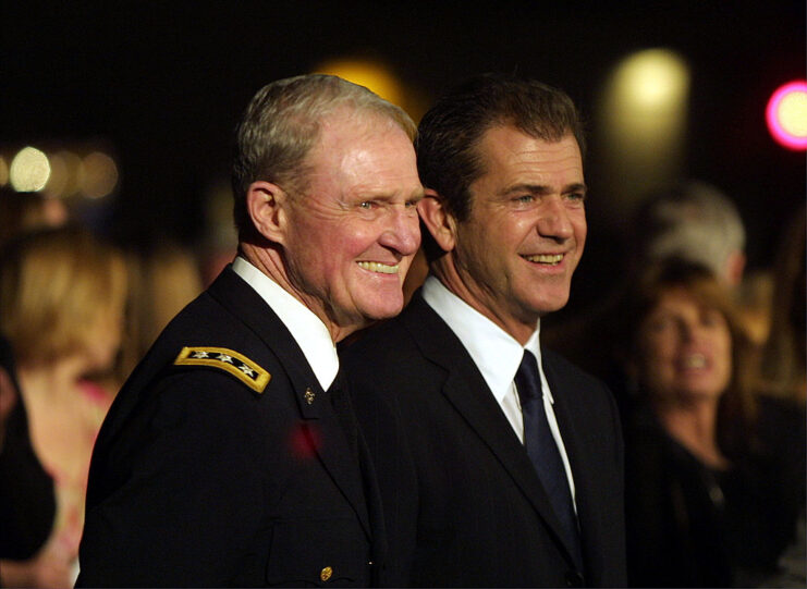 Hal Moore and Mel Gibson standing together on a red carpet