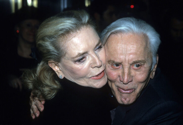 Lauren Bacall hugging Kirk Douglas