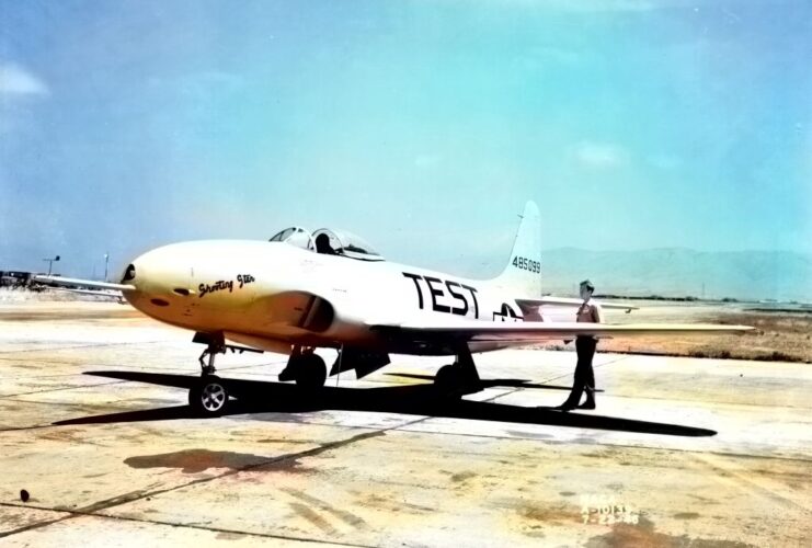 Individual standing beside a Lockheed P-80A Shooting Star