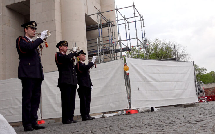 Three Belgian soldiers playing bugles