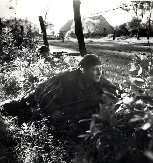 H.A. Marshall and S. Kormendy crouching in a roadside ditch