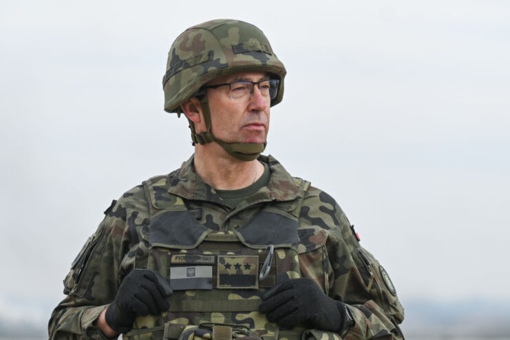 Tomasz Piotrowski dressed in military camouflage