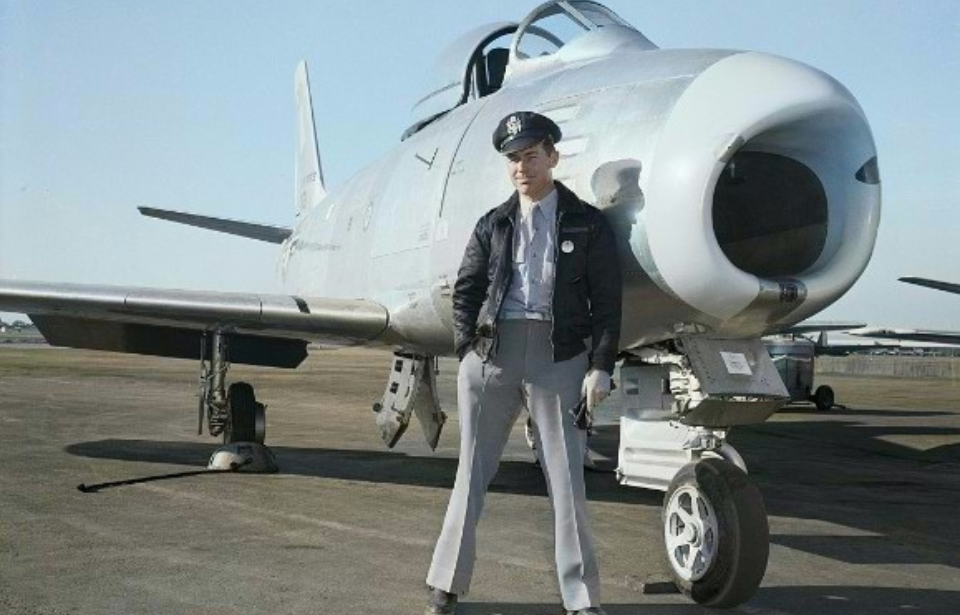 Chuck Yeager standing in front of an aircraft