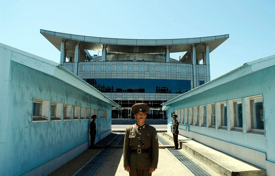 North Korean soldiers standing in front of the Military Demarcation Line between North and South Korea