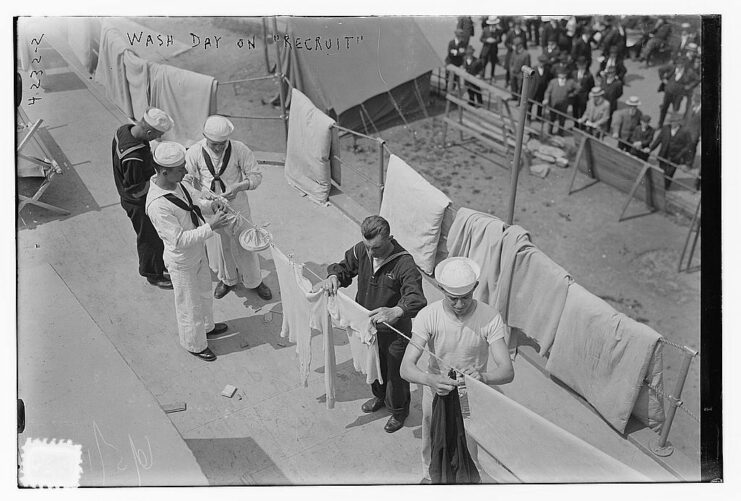 Sailors hanging laundry on a line
