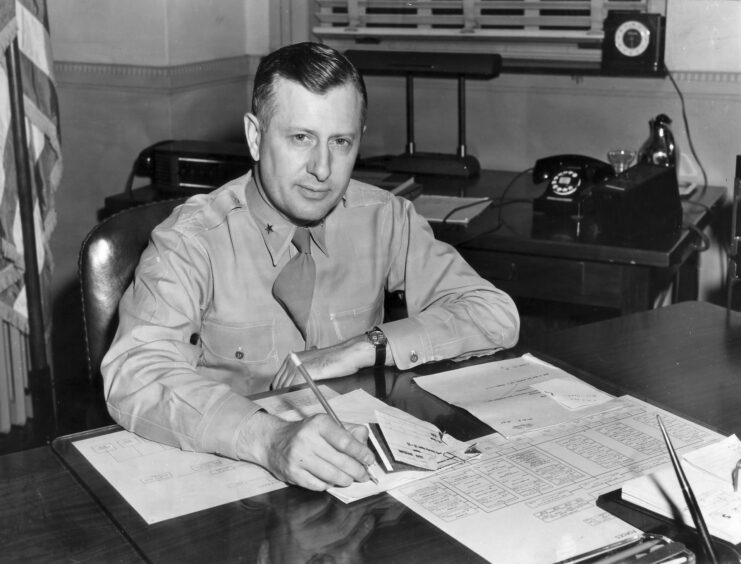 William H. Tunner working at a desk
