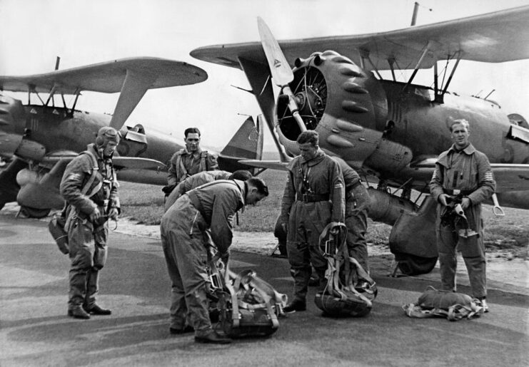 Luftwaffe pilots preparing parachutes in front of parked Henschel Hs 123s