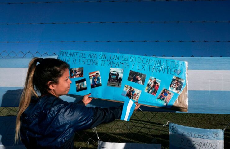 Malvina Vallejos standing in front of a homemade sign