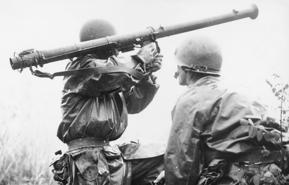 24th Infantry Division soldier manning a Bazooka while another crouches beside him