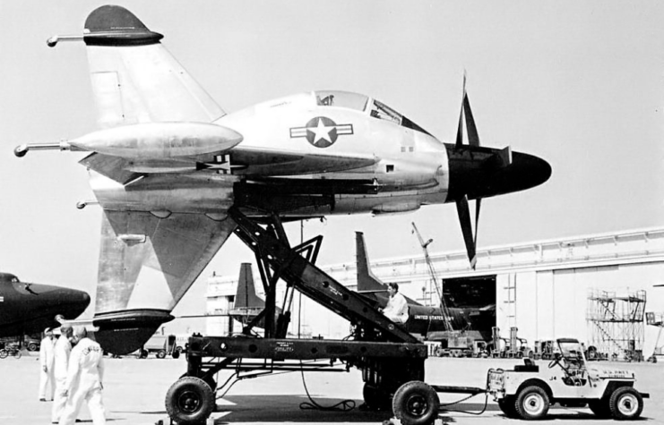 Crewmen standing beneath a Convair XFY Pogo on its launching cart