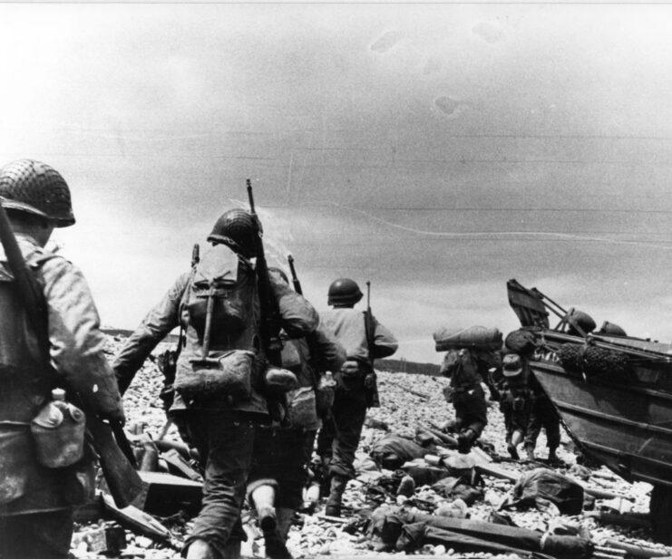 American assault troops running across a beach