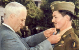 Harry S. Truman placing the Medal of Honor around Desmond Doss' neck