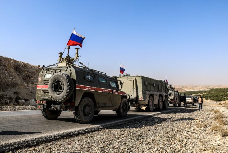 Russian military vehicles driving down a road