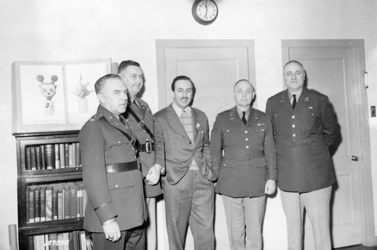 Walt Disney standing with four US military officials in his office