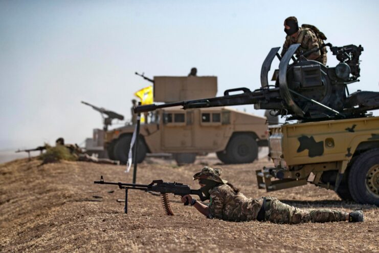 Syrian Democratic Forces (SDF) fighters manning weapons in the Syrian desert