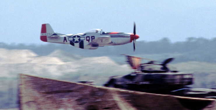 North American P-51 Mustang flying low over an object