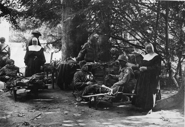 Two nuns standing watch over wounded German soldiers and US Army Capt. Alfred Owen