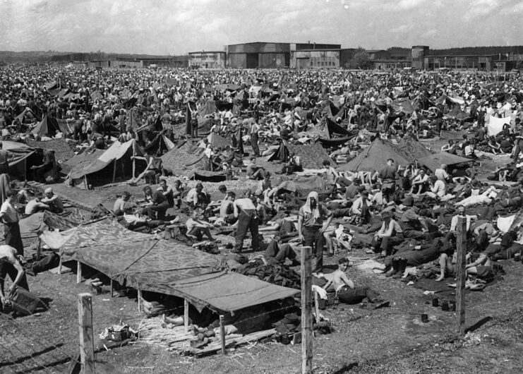 German prisoners of war (POWs) sitting among makeshift tents