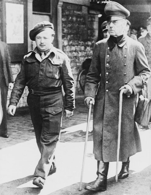 Gerd von Rundstedt being escorted by a soldier
