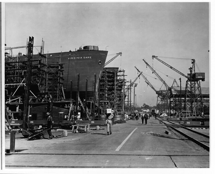 Shipbuilders and dock workers walking past the SS Virginia Dare