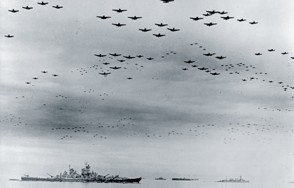 US naval aircraft flying over the USS Missouri (BB-63)