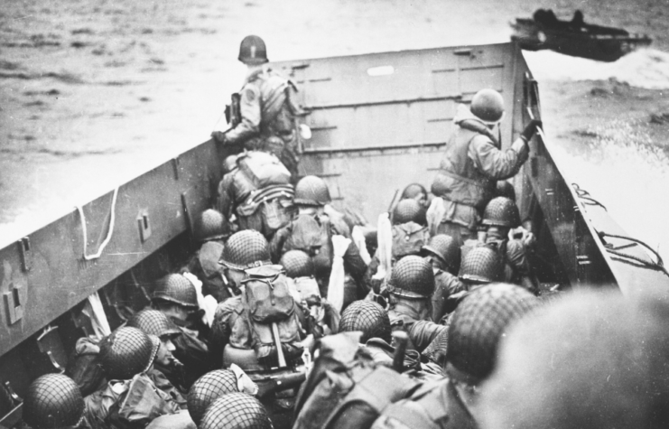 US personnel gathered together in a Higgins boat at sea