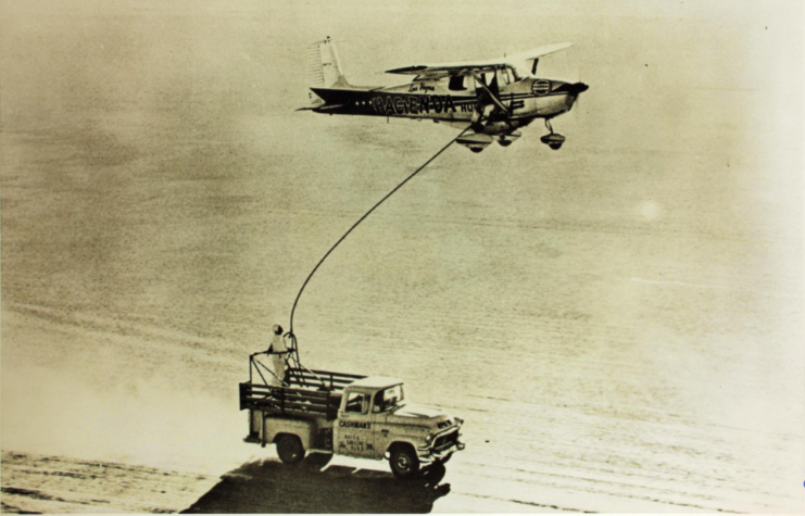 Cessna 172, in-flight, attached to a grounded truck via a fuel hose