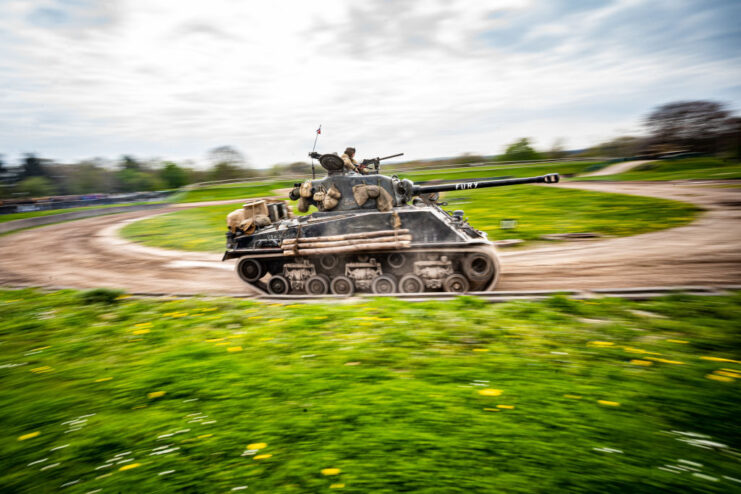 M4A2E8 Sherman 'Fury' driving along a dirt track