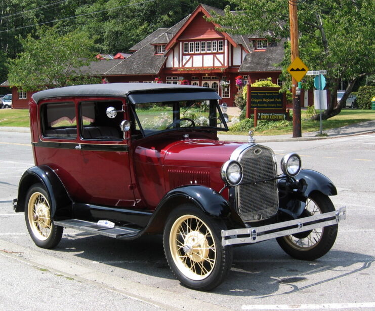 Model A Ford parked along a sidewalk