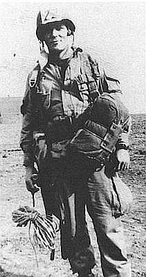 Richard Winters standing with his paratrooper gear
